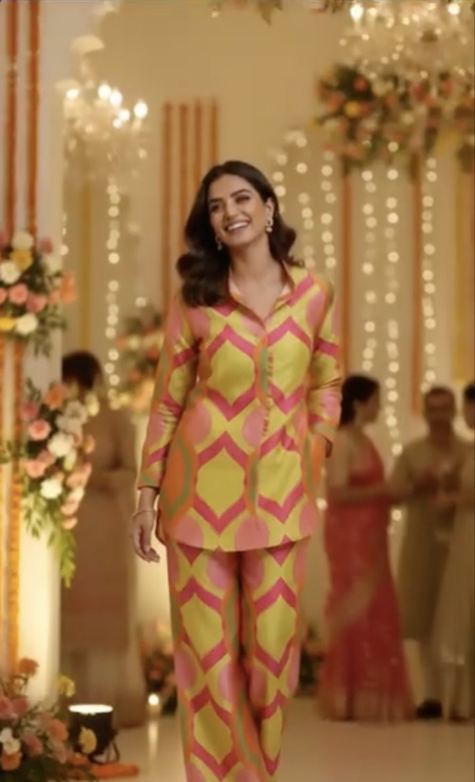 AI model wearing a ReStyle printed co-ord set in a festive hall