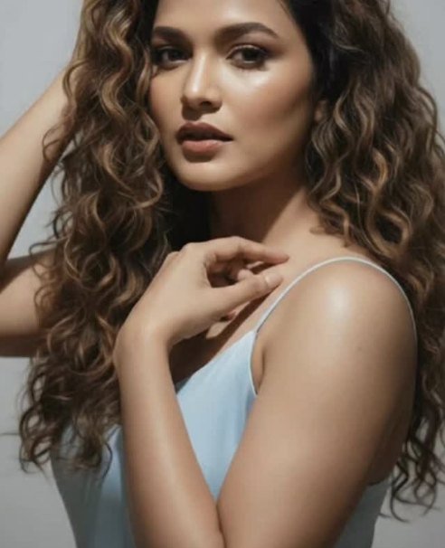 Tanvi in a studio portrait, pale blue dress